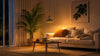 A modern living room showcasing a white couch, accented with colorful cushions and a sleek coffee table.
